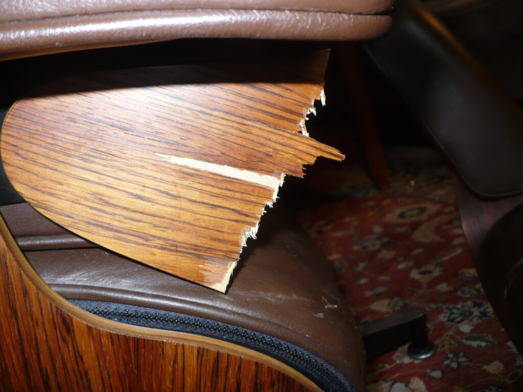 Eames lounge chair plywood shell broken through its veneer layers