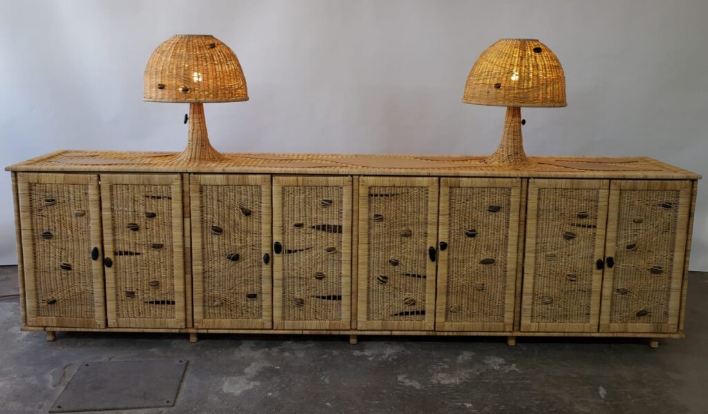Long custom sideboard with woven rattan-clad doors and matching rattan lamps