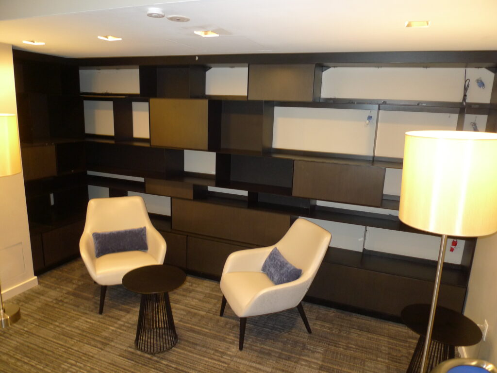 Two custom light-upholstered lounge chairs in a modern corporate lounge
