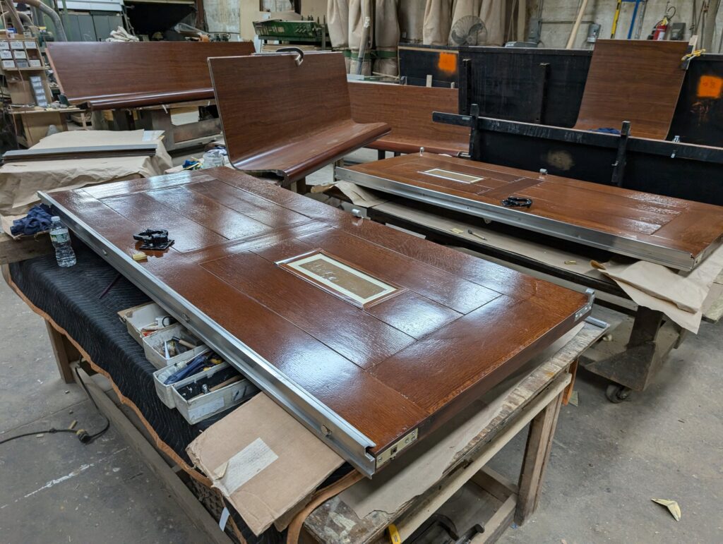 Rebuilt historic Riverside Church paneled timber door in the Olek restoration workshop