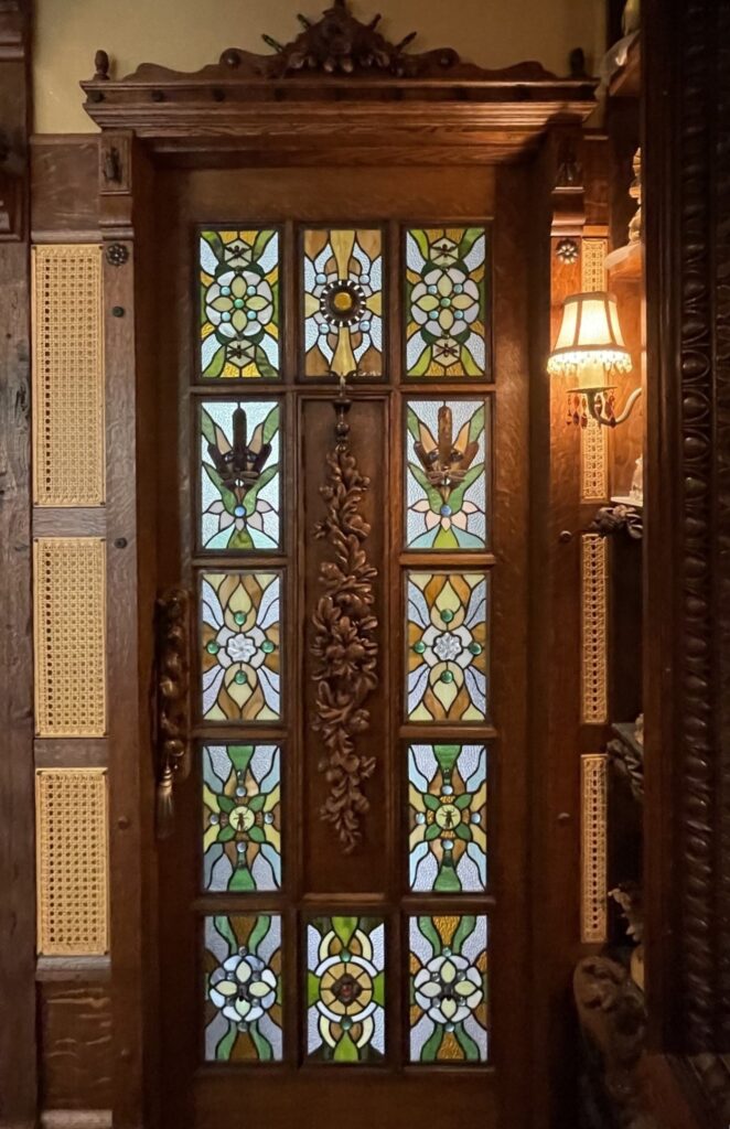 Carved wood door with custom leaded stained glass panels made for a client home