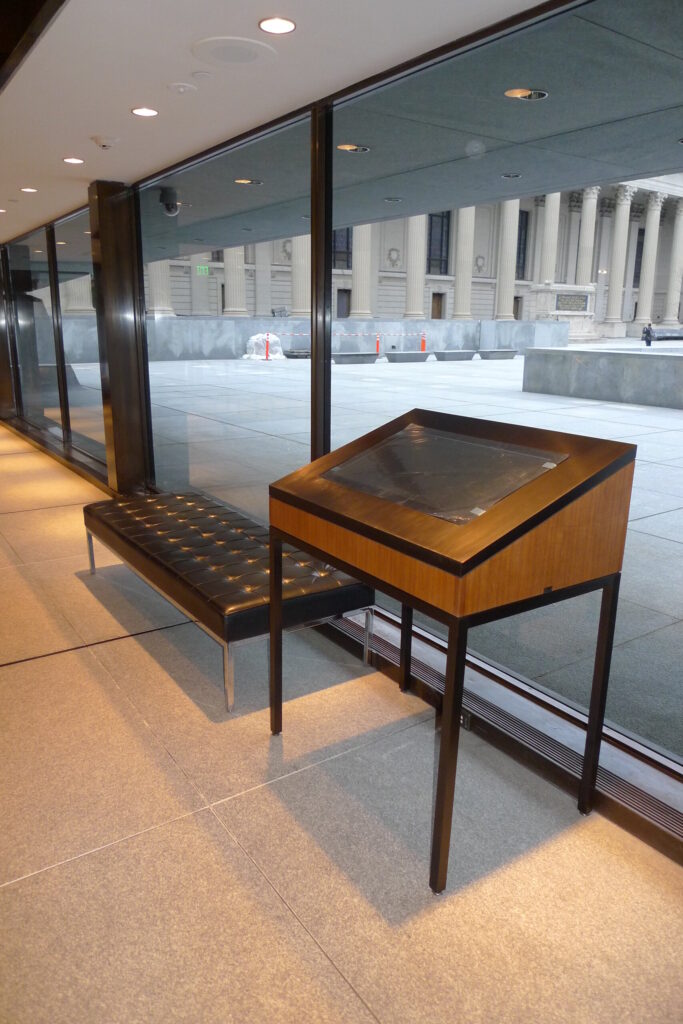 Custom bronze and wood digital podium in a Yale institutional setting
