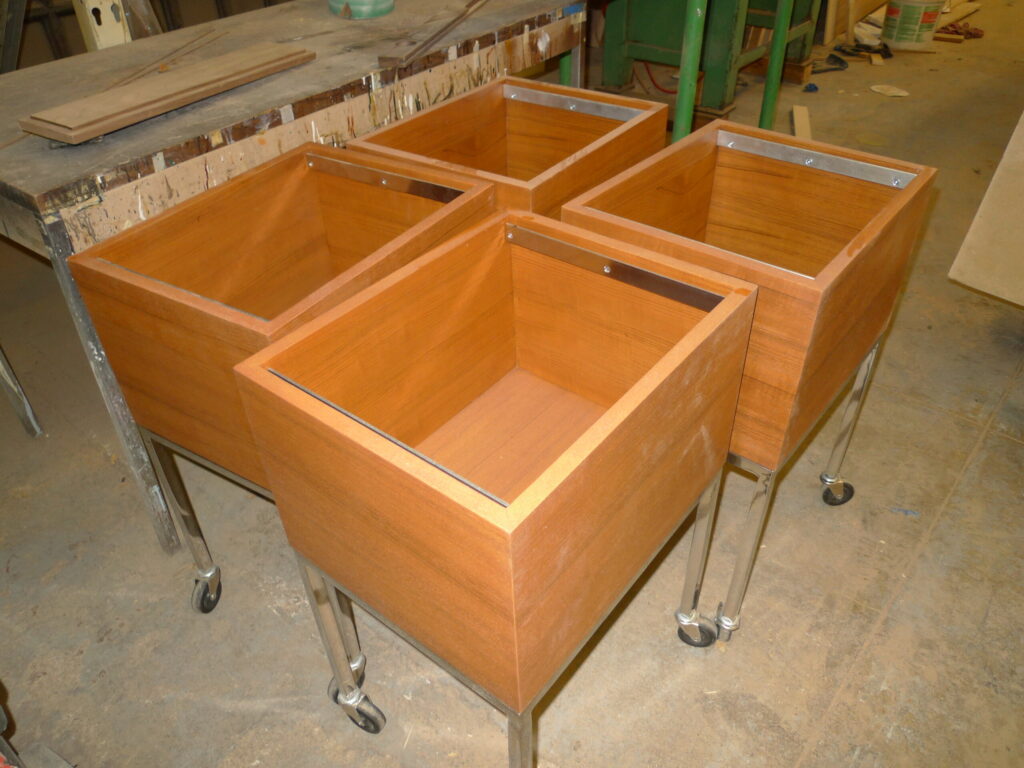 Custom teak rolling file storage fabrication in workshop